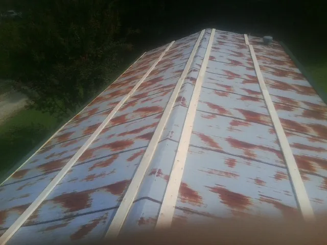 Rusted metal roof panels with new wood purlins before replacement — Storm Damage Roof Repair in Staunton by Roofing Brothers