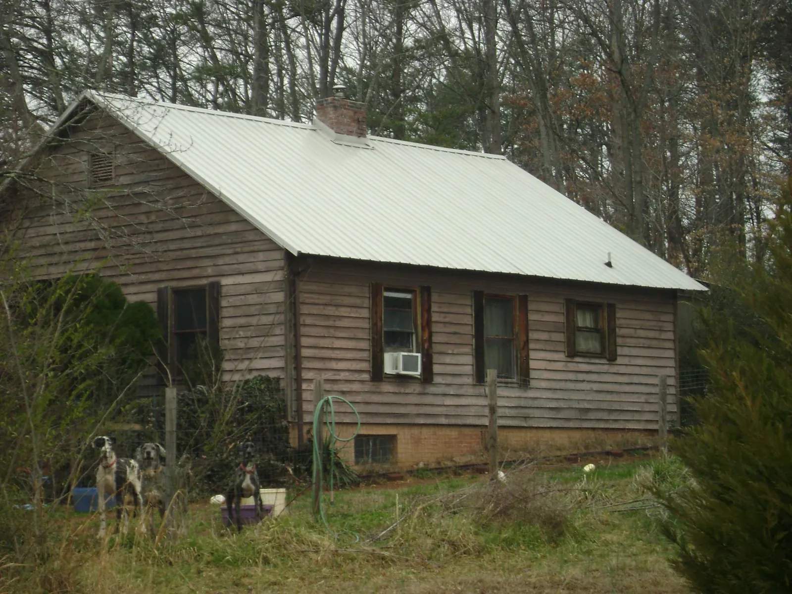 White metal roof on an old wood sided farmhouse, from a Metal Roof Installation job in Staunton